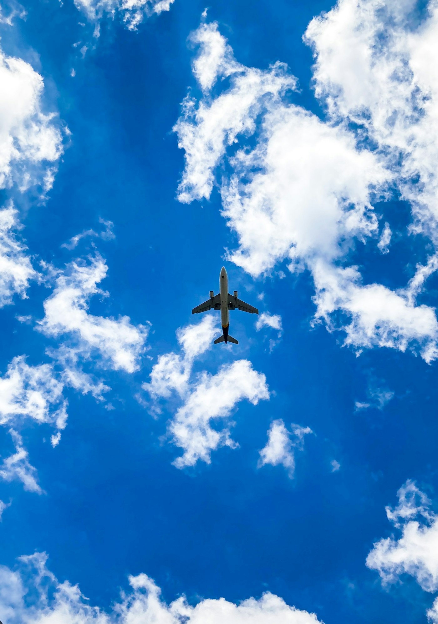 Aircraft overhead against a deep blue sky